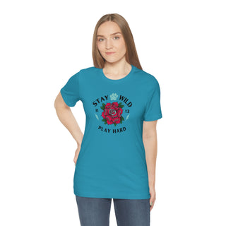 Stay Wild Unisex Premium Tee in Aqua. Shown is front of Stay Wild Design features a tattoo style rose with the phrase "Stay Wild, Play Hard" around it. The back of shirt features the Stay Wild Benefit Beagle Logo Design.