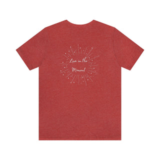 Live in the Moment Unisex Short Sleeve Tee in Red Heather. The Live in the Moment design features a graphic on the back with the phrase "Live in the Moment" surrounded by shooting stars.