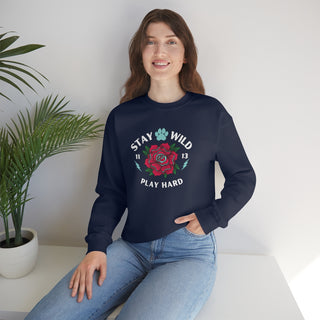 Stay Wild Unisex Heavy Blend Crewneck Sweatshirt in Navy. The Stay Wild Design features a tattoo style rose with the phrase "Stay Wild, Play Hard" around it. The back of shirt features the Stay Wild Benefit Beagle Logo Design.