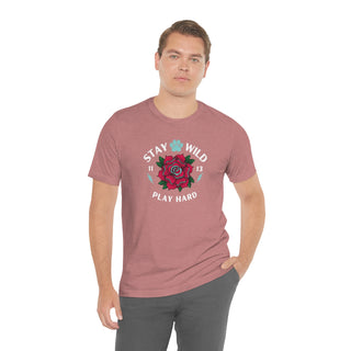 Stay Wild Unisex Premium Tee in Heather Mauve. Shown is front of Stay Wild Design features a tattoo style rose with the phrase "Stay Wild, Play Hard" around it. The back of shirt features the Stay Wild Benefit Beagle Logo Design.