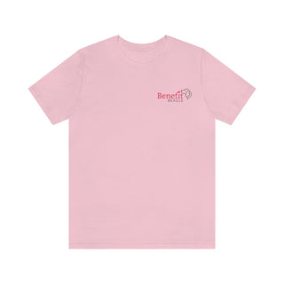 Different Pawspective Unisex Jersey Short Sleeve Tee in Pink. Shown is front of shirt with Benefit Beagle logo in the top corner . On the back is large colorful pawprint with the the phrase "Life is all about finding the beauty in a different pawspective" circled around it.