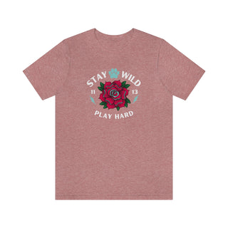 Stay Wild Unisex Premium Tee in Heather Mauve. Shown is front of Stay Wild Design features a tattoo style rose with the phrase "Stay Wild, Play Hard" around it. The back of shirt features the Stay Wild Benefit Beagle Logo Design.