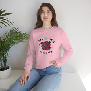 Stay Wild Unisex Heavy Blend Crewneck Sweatshirt in Pink. The Stay Wild Design features a tattoo style rose with the phrase "Stay Wild, Play Hard" around it. The back of shirt features the Stay Wild Benefit Beagle Logo Design.