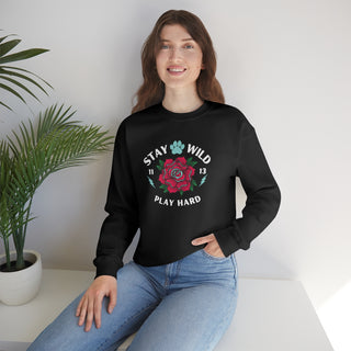 Stay Wild Unisex Heavy Blend Crewneck Sweatshirt in Black. The Stay Wild Design features a tattoo style rose with the phrase "Stay Wild, Play Hard" around it. The back of shirt features the Stay Wild Benefit Beagle Logo Design.