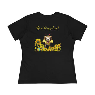 Bee Pawsitive Women's Premium Tee in Black. Shown is back of shirt showcasing a dog dressed as as bee in a a field of sunflowers with the phrase "Bee Pawsitive!" above it. The front features the Bee Pawsitive Benefit Beagle Logo.