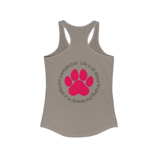 Different Pawspective Women's Racerback Tank in Warm Grey. Shown is the back of shirt featuring a large colorful pawprint with the the phrase "Life is all about finding the beauty in a different pawspective" circled around it. The Benefit Beagle Logo is located in the top corner on the front of shirt.