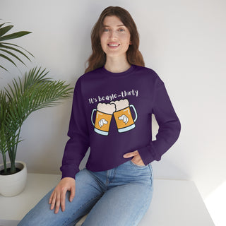 Beagle-Thirty Mugs Unisex Heavy Blend Crewneck Sweatshirt in Purple. The front of shirt showcases Two Dog Adorned Mugs clinking with the saying, "It's Beagle-Thirty" above it. Back of shirt features corresponding Benefit Beagle Logo.