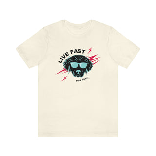 Play Hard Unisex Jersey Short Sleeve Tee Shirt in Natural. The design features a cool dog with sunglasses and lightening bolts around it. The phrase "Live Fast, Play Hard" is around the design.