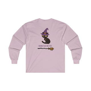 Witchy Cat Unisex Ultra Cotton Long Sleeve Tee. Back side shown in Light Pink with Wide Eyed Cartoon Cat wearing Purple Hat Standing over Broom. "Crossing Paths Since 1692". On the front of shirt is similar Witchy Benefit Beagle Logo. Purrfect for Halloween, or anytime!