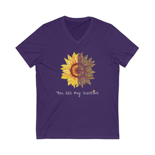 You are my Sunshine Unisex V-Neck Tee in Purple. Shown is the front showcasing a sunflower which is split down the middle and half is made out of paw prints. Underneath is the phrase "You are my Sunshine" . Back of shirt features the Sunflower Benefit Beagle Logo.