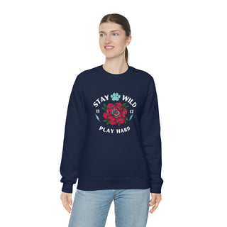 Stay Wild Unisex Heavy Blend Crewneck Sweatshirt in Navy. The Stay Wild Design features a tattoo style rose with the phrase "Stay Wild, Play Hard" around it. The back of shirt features the Stay Wild Benefit Beagle Logo Design.