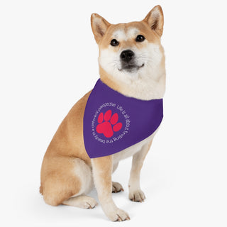 Dog wearing the Different Pawspective Dog Collar Bandana in Purple. The Different Pawspective design features the phrase "Life is all about finding the beauty in a different pawspective" around a paw print.