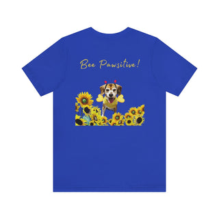 Bee Pawsitive Unisex Jersey Short Sleeve Tee shirt in True Royal. Shown is back of shirt showcasing a dog dressed as as bee in a a field of sunflowers with the phrase "Bee Pawsitive!" above it. The front features the Bee Pawsitive Benefit Beagle Logo.