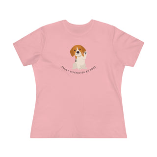 Easily Distracted Women's Premium Tee in Pink. Shown is front design featuring a dog waving with the saying "Easily Distracted by Dogs" below it. The back of shirt has the classic Benefit Beagle Logo.