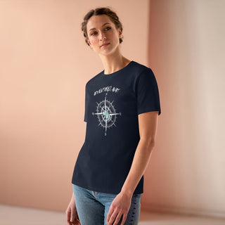 Adventures Await Women's Premium Tee in Navy. The front of shirt features the Adventures Await design with a dog inside a nautical compass and the words "Adventures Await" above it. The back of the shirt has similar Benefit Beagle Logo.