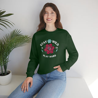 Stay Wild Unisex Heavy Blend Crewneck Sweatshirt in Forest Green. The Stay Wild Design features a tattoo style rose with the phrase "Stay Wild, Play Hard" around it. The back of shirt features the Stay Wild Benefit Beagle Logo Design.