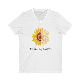 You are my Sunshine Unisex V-Neck Tee in White. Shown is the front showcasing a sunflower which is split down the middle and half is made out of paw prints. Underneath is the phrase "You are my Sunshine" . Back of shirt features the Sunflower Benefit Beagle Logo.