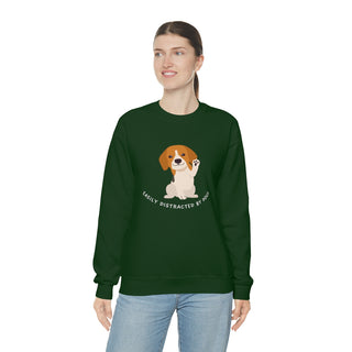 Easily Distracted Unisex Heavy Blend Crewneck Sweatshirt in Forest Green. Shown is front design featuring a dog waving with the saying "Easily Distracted by Dogs" below it. The back of shirt has the classic Benefit Beagle Logo.