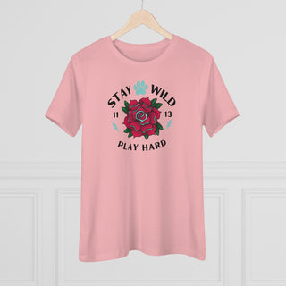 Stay Wild Women's Premium Tee in Pink. Shown is front of Stay Wild Design features a tattoo style rose with the phrase "Stay Wild, Play Hard" around it. The back of shirt features the Stay Wild Benefit Beagle Logo Design.