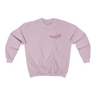 Different Pawspective Unisex Crewneck Sweatshirt in Light Pink. Shown is front of shirt with Benefit Beagle logo in the top corner . On the back is large colorful pawprint with the the phrase "Life is all about finding the beauty in a different pawspective" circled around it.