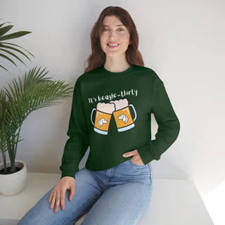 Beagle-Thirty Mugs Unisex Heavy Blend Crewneck Sweatshirt in Forest Green. The front of shirt showcases Two Dog Adorned Mugs clinking with the saying, "It's Beagle-Thirty" above it. Back of shirt features corresponding Benefit Beagle Logo.