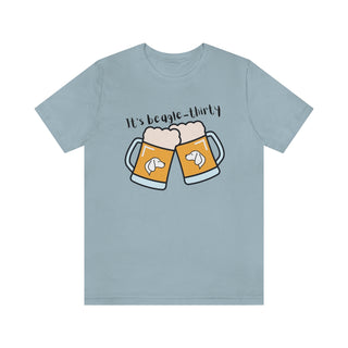 Beagle-Thirty Mugs Unisex Jersey Short Sleeve Tee in Light Blue. The front of shirt showcases Two Dog Adorned Mugs clinking with the saying, "It's Beagle-Thirty" above it. Back of shirt features corresponding Benefit Beagle Logo.