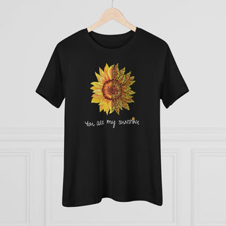 You are my Sunshine Women's Premium Tee shirt in Black. Shown is the front showcasing a sunflower which is split down the middle and half is made out of paw prints. Underneath is the phrase "You are my Sunshine" . Back of shirt features the Sunflower Benefit Beagle Logo.