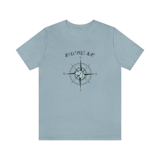 Adventures Await Unisex Jersey Short Sleeve Tee in Light Blue. The front of shirt features the Adventures Await design with a dog inside a nautical compass and the words "Adventures Await" above it. The back of the shirt has similar Benefit Beagle Logo.