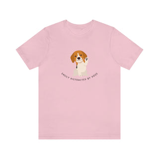 Easily Distracted Unisex Jersey Short Sleeve Tee in Pink. Shown is front design featuring a dog waving with the saying "Easily Distracted by Dogs" below it. The back of shirt has the classic Benefit Beagle Logo.