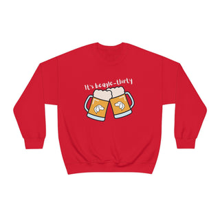 Beagle-Thirty Mugs Unisex Heavy Blend Crewneck Sweatshirt in Red. The front of shirt showcases Two Dog Adorned Mugs clinking with the saying, "It's Beagle-Thirty" above it. Back of shirt features corresponding Benefit Beagle Logo.