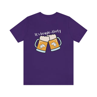 Beagle-Thirty Mugs Unisex Jersey Short Sleeve Tee in Team Purple. The front of shirt showcases Two Dog Adorned Mugs clinking with the saying, "It's Beagle-Thirty" above it. Back of shirt features corresponding Benefit Beagle Logo.