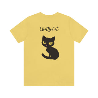 Meow Unisex Tee in Yellow. Shown is back showcasing a wide eyed black cartoon cat with the phrase "Chatty Cat" above it. On front of shirt is the Benefit Beagle Logo featuring a peeping cat.