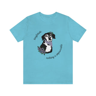 Signature Tattoo Flowers Unisex Jersey Short Sleeve Tee in Turquoise. Shown is front of shirt with the Signature Tattoo Flowers design featuring a dog with flowers around it and the phrase "Beagletude" and "Nothing is Impawssible". Back of shirt features the Benefit Beagle Logo.