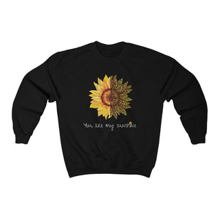 You are my Sunshine Unisex Crewneck Sweatshirt in Black. Shown is the front showcasing a sunflower which is split down the middle and half is made out of paw prints. Underneath is the phrase "You are my Sunshine" . Back of shirt features the Sunflower Benefit Beagle Logo.