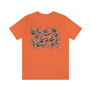 Dia De Los Muertos Unisex Jersey Short Sleeve Tee Shirt in Orange. Shown is the front of shirt featuring print of dogs and cats with Dia de los Muertos traditional decorations. On the back is a similar Benefit Beagle Logo.