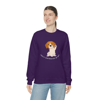 Easily Distracted Unisex Heavy Blend Crewneck Sweatshirt in Purple. Shown is front design featuring a dog waving with the saying "Easily Distracted by Dogs" below it. The back of shirt has the classic Benefit Beagle Logo.