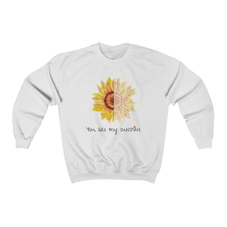 You are my Sunshine Unisex Crewneck Sweatshirt in White. Shown is the front showcasing a sunflower which is split down the middle and half is made out of paw prints. Underneath is the phrase "You are my Sunshine" . Back of shirt features the Sunflower Benefit Beagle Logo.