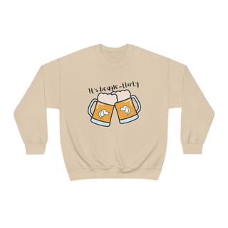 Beagle-Thirty Mugs Unisex Heavy Blend Crewneck Sweatshirt in Sand. The front of shirt showcases Two Dog Adorned Mugs clinking with the saying, "It's Beagle-Thirty" above it. Back of shirt features corresponding Benefit Beagle Logo.