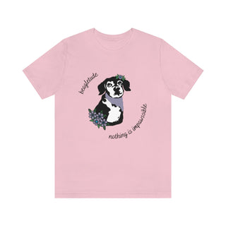 Signature Tattoo Flowers Unisex Jersey Short Sleeve Tee in Pink. Shown is front of shirt with the Signature Tattoo Flowers design featuring a dog with flowers around it and the phrase "Beagletude" and "Nothing is Impawssible". Back of shirt features the Benefit Beagle Logo.