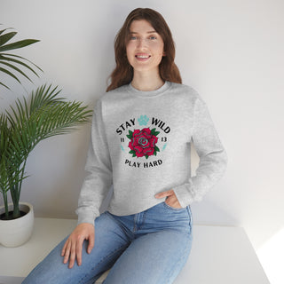 Stay Wild Unisex Heavy Blend Crewneck Sweatshirt in Ash. The Stay Wild Design features a tattoo style rose with the phrase "Stay Wild, Play Hard" around it. The back of shirt features the Stay Wild Benefit Beagle Logo Design.