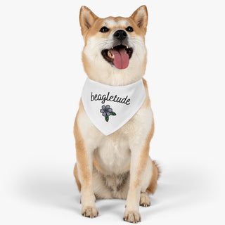 Dog wearing the Signature Tattoo Flower Dog Collar Bandana in White. The Signature Tattoo Flower design features the word "beagletude" with a tattoo style flower under it. Comes with adjustable black collar.