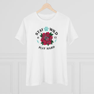 Stay Wild Women's Premium Tee in White. Shown is front of Stay Wild Design features a tattoo style rose with the phrase "Stay Wild, Play Hard" around it. The back of shirt features the Stay Wild Benefit Beagle Logo Design.