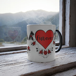 Color morphing mug with dogs with bowties and roses and the center hearts reading, "be mine" and "furever". Mug is white with design when filled with hot beverage. When cool or empty, mug color morphs to dark.