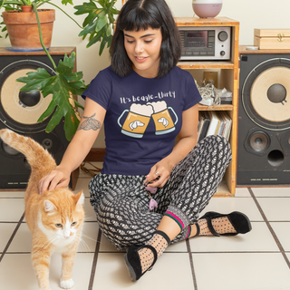 Beagle-Thirty Mugs Unisex Jersey Short Sleeve Tee in Navy. The front of shirt showcases Two Dog Adorned Mugs clinking with the saying, "It's Beagle-Thirty" above it.  Back of shirt features corresponding Benefit Beagle Logo. 