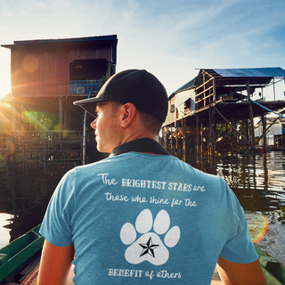 Brightest Star unisex Short Sleeve Tee shirt in blue. The Brightest Star design features a design on the back with the phrase "The brightest stars are those who shine for the benefit of others" with a pawprint and a nautical star.