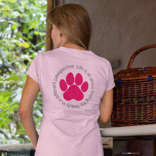 Different Pawspective Women's Premium Tee in Pink. Shown is the back of shirt featuring a large colorful pawprint with the the phrase "Life is all about finding the beauty in a different pawspective" circled around it. The Benefit Beagle Logo is located in the top corner on the front of shirt.