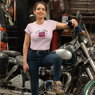 Stay Wild Women's Premium Tee in Pink. Shown is front of Stay Wild Design features a tattoo style rose with the phrase "Stay Wild, Play Hard" around it. The back of shirt features the Stay Wild Benefit Beagle Logo Design.