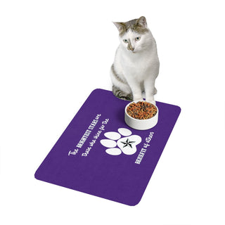 Brightest Star pet food mat in Purple. The Brightest Star design features a design on the back with the phrase "The brightest stars are those who shine for the benefit of others" with a pawprint and a nautical star. Bowl of cat food with adoring cat for scale. 