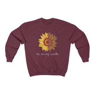 You are my Sunshine Unisex Crewneck Sweatshirt in Maroon. Shown is the front showcasing a sunflower which is split down the middle and half is made out of paw prints. Underneath is the phrase "You are my Sunshine" . Back of shirt features the Sunflower Benefit Beagle Logo.