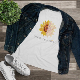 You are my Sunshine Women's Premium Tee shirt in White. Shown is the front showcasing a sunflower which is split down the middle and half is made out of paw prints. Underneath is the phrase "You are my Sunshine" . Back of shirt features the Sunflower Benefit Beagle Logo.